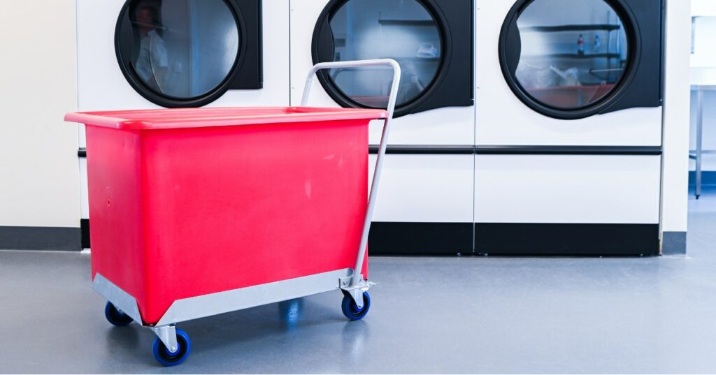 Red Plastic Tub Trolley with push handle in laundry facility